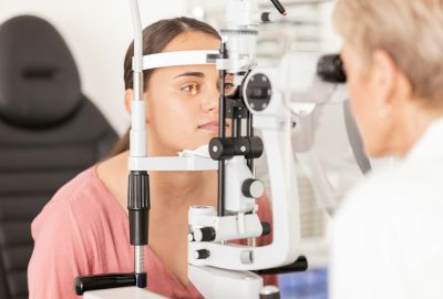 Eye, optometrist and eye exam in ophthalmologist office with optical machine to examine vision weak