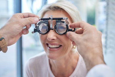 Happy customer in a vision test or eye exam for eyesight by doctor, optometrist or ophthalmologist